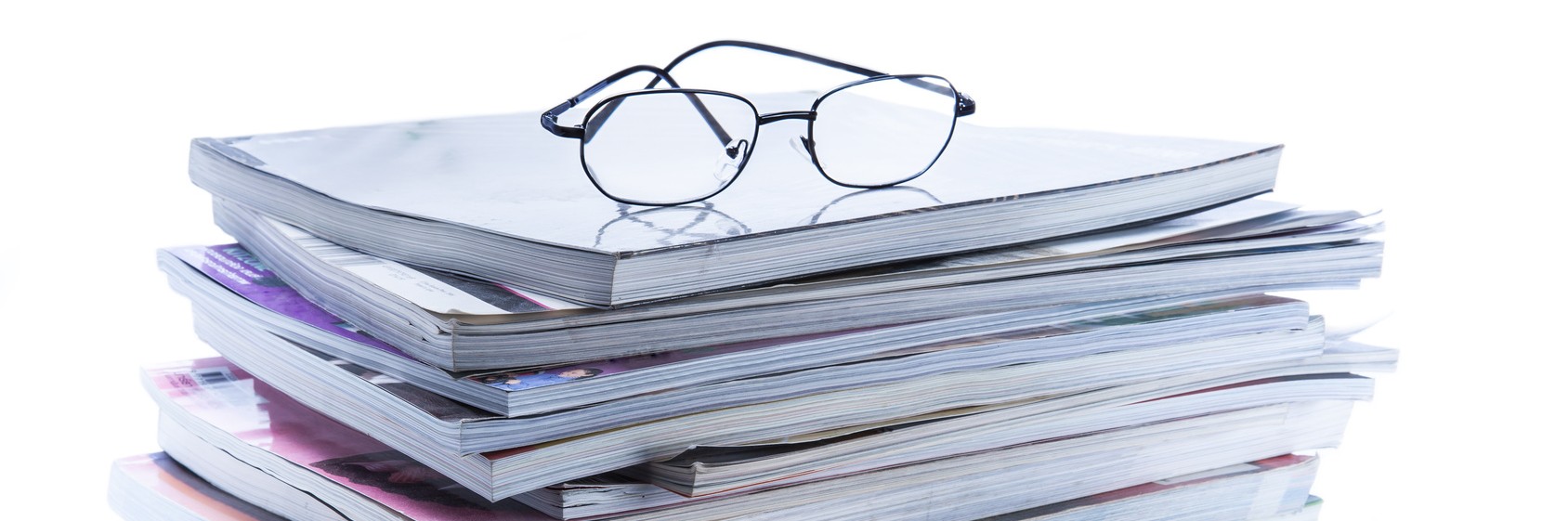 magazine and book stack with glasses magazine and book stack with glasses